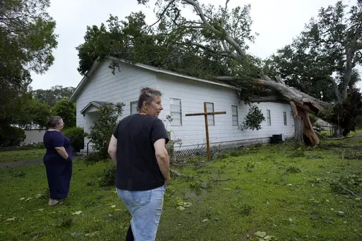 Ann McCauley, right, examines the damage at Bethel Church after Hurricane Beryl moved through the area July 8, 2024, in Van Vleck, Texas. (AP Photo/Eric Gay, File)