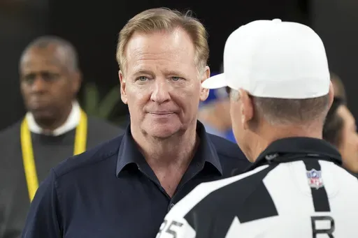 NFL Commissioner Roger Goodell, left, talks with Referee John Hussey before an NFL wild card playoff football game between the Los Angeles Rams and Minnesota Vikings, Monday, Jan. 13, 2025, in Glendale, Ariz. (AP Photo/Ross D. Franklin)