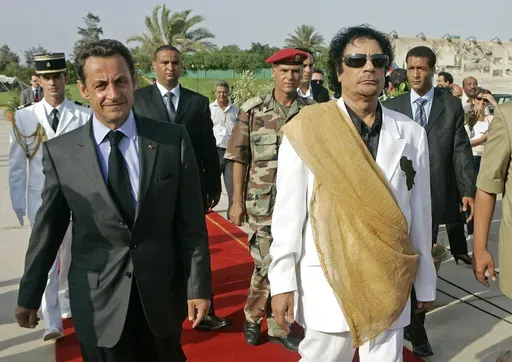 Libyan leader Moammar Gadhafi, right, welcomes French President Nicolas Sarkozy at the Bab Azizia Palace in Tripoli, July 25, 2007. (AP Photo/Michel Euler, File)