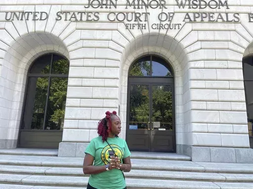 Teliah Perkins stands in front of the federal appeals court building in New Orleans, May 3, 2023, following a hearing on her lawsuit against two St. Tammany Parish, La., sheriff's deputies stemming from her arrest in May 2020. A teenager who video-recorded his mother Teliah's forceful arrest by Louisiana sheriff's deputies has been awarded $185,000 by a federal jury in a lawsuit filed over one deputy's attempt to interfere with the recording. (AP Photo/Kevin McGill, File)
