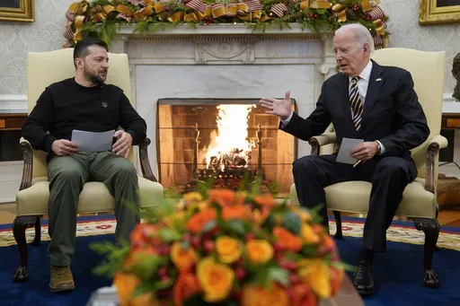 President Joe Biden reaches out to shake hands with Ukrainian President Volodymyr Zelenskyy as they meet in the Oval Office of the White House, Tuesday, Dec. 12, 2023, in Washington. The White House says funding for Ukraine has run out and it has been increasing pressure on Congress to pass stalled legislation to support the war against Russia. On Tuesday, however, Biden touted a new military aid package worth $200 million for Ukraine. That may seem contradictory, but it’s due to the complex p