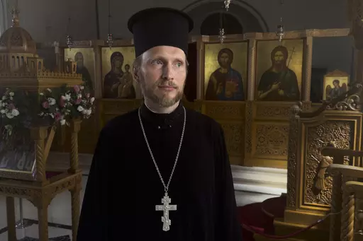The Rev. Ioann Koval stands inside an old Orthodox church in Antalya, Turkey, Sunday, July 16, 2023. Koval started serving in this church after the Russian Orthodox Church leadership decided to defrock him following his prayer for peace in Ukraine. Koval, who used to serve in a church in Moscow, appealed the decision to Ecumenical Patriarch Bartholomew of Constantinople, and the Constantinople ruled to restore his holy rank, allowing him to serve in one of its churches. (AP Photo/Kostya Manenkov