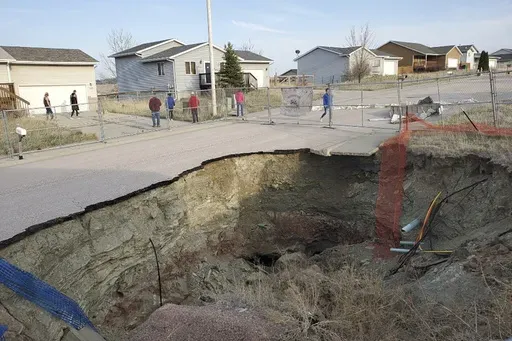 This photo taken April 27, 2022, by Tonya Junker shows a sinkhole in the Hideaway Hills neighborhood near Rapid City, S.D. (Tonya Junker via AP)