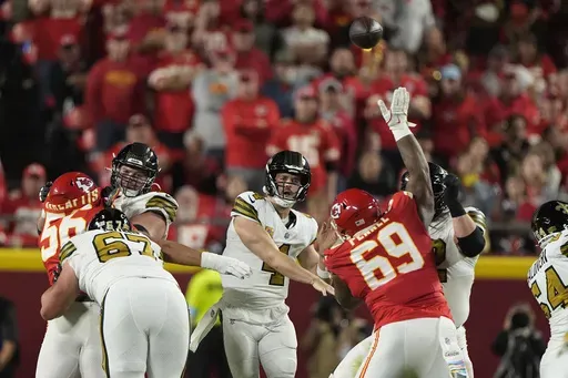 New Orleans Saints quarterback Derek Carr (4) throws over Kansas City Chiefs nose tackle Mike Pennel (69) during the first half of an NFL football game Monday, Oct. 7, 2024, in Kansas City, Mo. (AP Photo/Charlie Riedel)