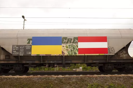 A Ukrainian an Austrian flag is painted on a freight train with fodder maize, arriving from the Ukraine in Vienna, Austria, Friday, May 6, 2022. (AP Photo/Theresa Wey)