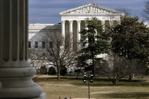 The Supreme Court is seen in the distance, framed through columns of the U.S. Senate at the Capitol in Washington, Feb. 20, 2025. (AP Photo/J. Scott Applewhite, File)