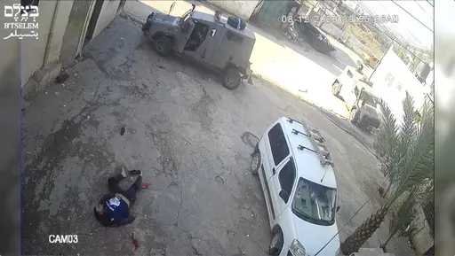 This image taken from video taken on Dec 8, 2023, in the Faraa refuge camp shows soldiers shooting down the men at close range when they did not appear to pose a threat. Security footage obtained by the Israeli human rights group B'Tselem shows two Israeli soldiers pursuing shooting the men — one while he was incapacitated and the other appearing to be unarmed — during a raid in a West Bank refugee camp. (B'Tselem via AP)