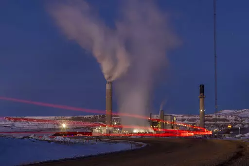 In this photo taken with a slow shutter speed, taillights trace the path of a motor vehicle at the Naughton Power Plant, Thursday, Jan. 13, 2022, in Kemmerer, Wyo. While the power plant will be closed in 2025, Bill Gates' company TerraPower announced it had chosen Kemmerer for a nontraditional, sodium-cooled nuclear reactor that will bring on workers from a local coal-fired power plant scheduled to close soon. The U.S. nuclear industry has provided a steady 20% of the nation's power for years, b