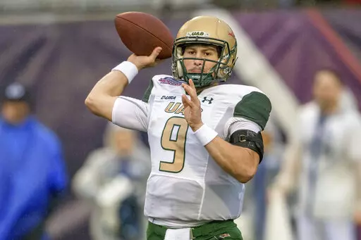UAB quarterback Dylan Hopkins (9) looks to throw during the first half of the Independence Bowl NCAA college football game against BYU in Shreveport, La., Saturday, Dec. 18, 2021. (AP Photo/Matthew Hinton)