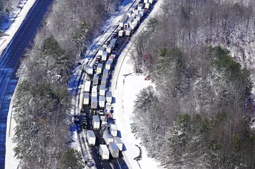 Drivers wait for the traffic to be cleared as cars and trucks are stranded on sections of Interstate 95 Tuesday Jan. 4, 2022, in Carmel Church, Va. Close to 48 miles of the Interstate was closed due to ice and snow. (AP Photo/Steve Helber)