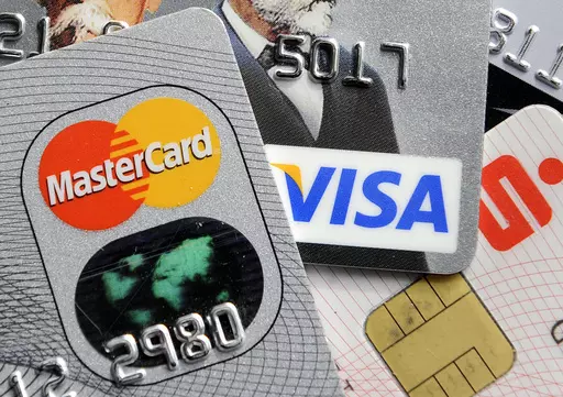 This Nov. 18, 2009, file photo, shows credit and bank cards with electronic chips in Gelsenkirchen, Germany. Are you getting the most out of your credit cards? It’s easy to keep using the same plastic, but fees and benefits change all the time. Investigate all the benefits each card offers, since you may have forgotten some and some may have been added. Then total up other monetary benefits — such as cash back — that you gained over the past year and compare that to the annual fee. (AP Pho