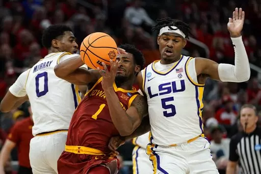 Iowa State's Izaiah Brockington is fouled as he drives between LSU's Brandon Murray and Mwani Wilkinson during the second half of a first round NCAA college basketball tournament game Friday, March 18, 2022, in Milwaukee. (AP Photo/Morry Gash)