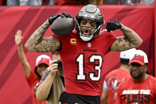 Tampa Bay Buccaneers wide receiver Mike Evans celebrates after scoring against the Carolina Panthers during the first half of an NFL football game Sunday, Dec. 29, 2024, in Tampa, Fla. (AP Photo/Jason Behnken)