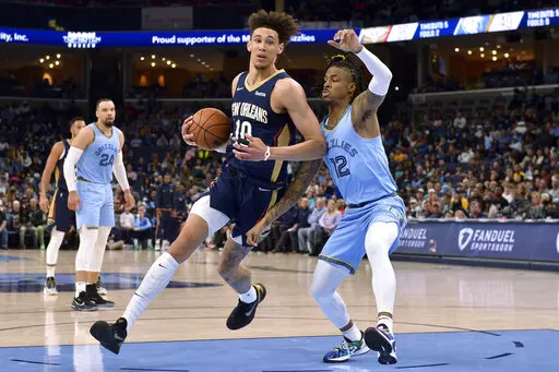 New Orleans Pelicans center Jaxson Hayes (10) drives against Memphis Grizzlies guard Ja Morant (12) during the first half of an NBA basketball game Saturday, April 9, 2022, in Memphis, Tenn. (AP Photo/Brandon Dill)