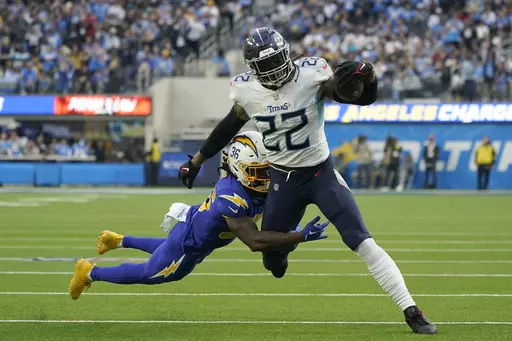Tennessee Titans running back Derrick Henry (22) runs against Los Angeles Chargers cornerback Ja'Sir Taylor (36) during the first half of an NFL football game in Inglewood, Calif., Sunday, Dec. 18, 2022. Henry is perhaps the best dominant runner in the game with more than 1,500 yards on the ground in three of the past four seasons. (AP Photo/Marcio Jose Sanchez, File)
