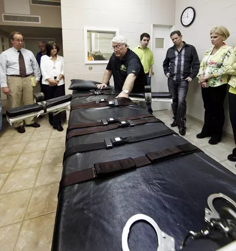 In this Sept. 18, 2009, file photo, Warden of the Louisiana State Penitentiary, Burl Cain, discusses the gurney used for lethal injections to Ruth Graham, far right and others as they visit the Louisiana State Penitentiary in Angola, La. For the fifth time in six years, Louisiana lawmakers have blocked attempts Wednesday, May 24, 2023 to abolish the state’s death penalty. (AP Photo/Judi Bottoni, File)