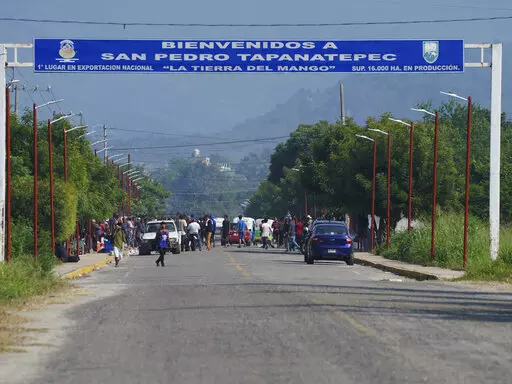 Migrants, mostly from Venezuela, arrive at a camp where Mexican authorities will arrange permits for their continued travel north, in San Pedro Tapanatepec, Oaxaca, Mexico Wednesday, Oct. 5, 2022. As migrants, especially Venezuelans, struggle to come to terms with a new U.S. policy discouraging border crossings, the town of San Pedro Tapanatepec is unexpectedly playing host to over 10,000 migrants camped far from the U.S. border.  (AP Photo/Marco Ugarte)