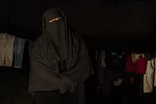 Marwa Ahmad poses for a photo in Raqqa, Syria, Wednesday, Dec. 28, 2022. Ahmad is among tens of thousands of widows and wives of IS militants who were detained in the wretched and lawless al-Hol camp in northeastern Syria after U.S.-led coalition and Syrian Kurdish forces cleared IS from northeastern Syria in 2019. (AP Photo/Baderkhan Ahmad)