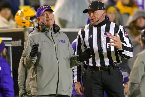 LSU coach Brian Kelly listens to an official on sideline during the second half the team's NCAA college football game against UAB in Baton Rouge, La., Saturday, Nov. 19, 2022. (AP Photo/Matthew Hinton)