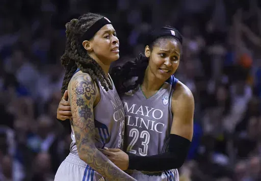 Minnesota Lynx guard Seimone Augustus (33) and forward Maya Moore (23) embrace after Game 5 of the team's WNBA Finals against the Los Angeles Sparks, Oct. 4, 2017 in Minneapolis. The Women’s Basketball Hall of Fame had a huge Minnesota feel to it with the induction of Moore and Augustus getting enshrined on Saturday, April 25, 2024. (Aaron Lavinsky/Star Tribune via AP, File)