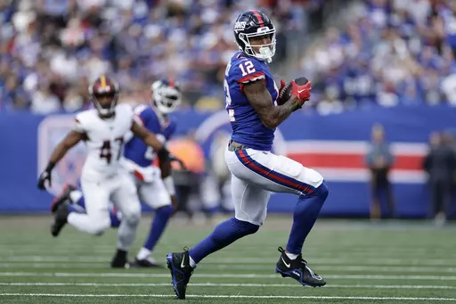 New York Giants tight end Darren Waller (12) makes a catch against the Washington Commanders during the first quarter of an NFL football game, Oct. 22, 2023, in East Rutherford, N.J. The Giants activated Waller from injured reserve and waived veteran safety Bobby McCain on Saturday, Dec. 16. (AP Photo/Adam Hunger, File)