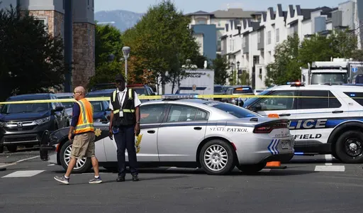 Law enforcement officials at the scene of a shooting in an apartment complex early Thursday, Sept. 12, 2024, in Broomfield, Colo. (AP Photo/David Zalubowski)