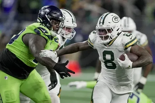 Green Bay Packers' Josh Jacobs runs for a first down during the first half of an NFL football game against the Seattle Seahawks Sunday, Dec. 15, 2024, in Seattle. (AP Photo/Stephen Brashear)