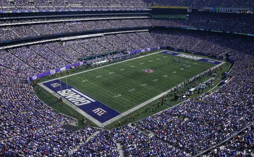The New York Giants play against the Carolina Panthers during the first half an NFL football game Sept. 18, 2022, in East Rutherford, N.J. The NFL Players Association is calling on six venues, including East Rutherford, to change their current playing surfaces, saying the turf in those stadiums results in “statistically higher in-game injury rates” involving non-contact and lower-extremity injuries. (AP Photo/Seth Wenig, File)