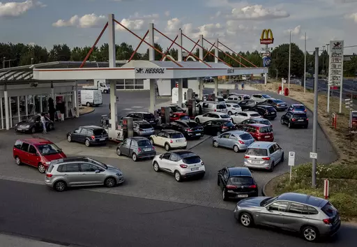 People queue with their cars at a gas station in Frankfurt, Germany, on Aug. 31, 2022, the last day when the government's fuel prize discount is in effect. Major oil-producing countries led by Saudi Arabia and Russia have said they're throttling back supplies of crude — again. And this time, the decision to cut back was a surprise that is underlining worries about where the global economy might be headed. (AP Photo/Michael Probst, File)