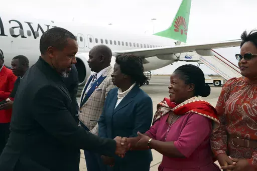Malawi Vice President Saulos Chilima, left, greets government officials upon his return from South Korea in Lillongwe, Sunday, June 9, 2024. A military plane carrying Malawi's vice president and nine others went missing Monday and a search was underway, the president's office said. The plane carrying 51-year-old Vice President Saulos Chilima left the capital, Lilongwe, but failed to make its scheduled landing at Mzuzu International Airport about 370 kilometers (230 miles) to the north around 45 