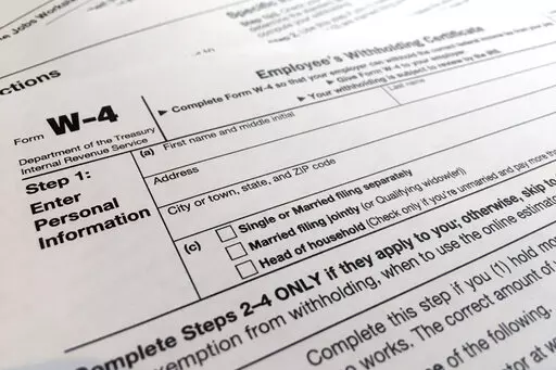 A W-4 form on Feb. 5, 2020, in New York. Monday is Tax Day, the federal deadline for individual tax filing and payments. The IRS will receive tens of millions of filings electronically and through paper forms. (AP Photo/Patrick Sison, File)