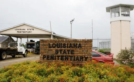 Vehicles enter at the main security gate at the Louisiana State Penitentiary — the Angola Prison, in Angola, La., Aug. 5, 2008. (AP Photo/Judi Bottoni, File)