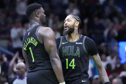 New Orleans Pelicans forward Brandon Ingram (14) and forward Zion Williamson (1) celebrate their back to back baskets late in the second half of an NBA basketball game against the Denver Nuggets in New Orleans, Friday, Nov. 17, 2023. The Pelicans won 115-110. (AP Photo/Gerald Herbert)