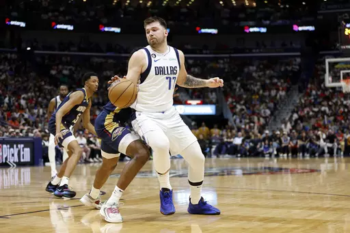 Dallas Mavericks guard Luka Doncic (77) drives past New Orleans Pelicans forward Herbert Jones (5) in the second half of an NBA basketball game in New Orleans, Wednesday, March 8, 2023. The Pelicans won 113-106. (AP Photo/Tyler Kaufman)