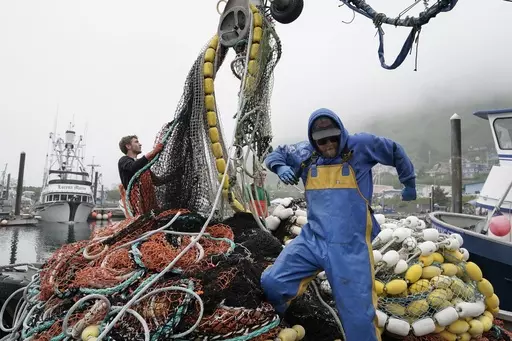 Salmon fisherman stack their nets on June 22, 2023, in Kodiak, Alaska. A group of lawmakers from New England and Alaska introduced a proposal Thursday, Dec. 7, 2023, that says a federal program that protects the health and wellbeing of commercial fishermen should be expanded to include substance use disorder and worker fatigue. (AP Photo/Joshua A. Bickel, File)