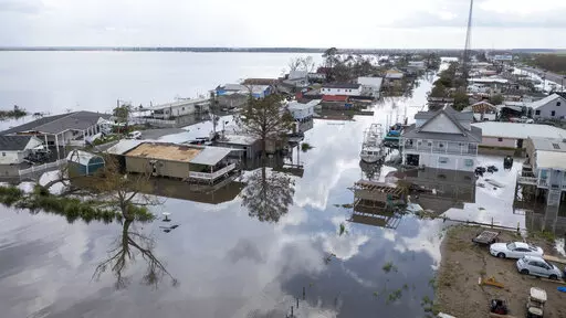 In this aerial photo taken with a drone, flood waters surround storm damaged homes on Aug. 31, 2021, in Lafourche Parish, La., as residents try to recover from the effects of Hurricane Ida. Ten Filipino men who worked for a major offshore oil industry employer claim in a federal lawsuit in Feburary 2022 that they were treated like prisoners at a company bunkhouse — and that two of them were abandoned there when Hurricane Ida struck the Louisiana Gulf Coast in 2021. (AP Photo/Steve Helber, File