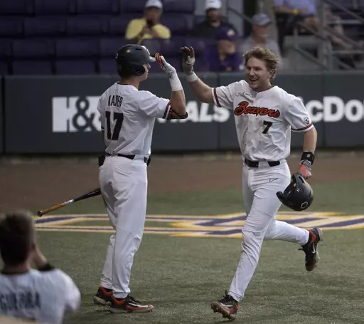 Oregon State's Mikey Kane (7) celebrates with right fielder Brady Kasper (17) after scoring against Sam Houston State during an NCAA college baseball tournament regional game Friday, June 2, 2023, in Baton Rouge, La. (Hilary Scheinu/The Advocate via AP)