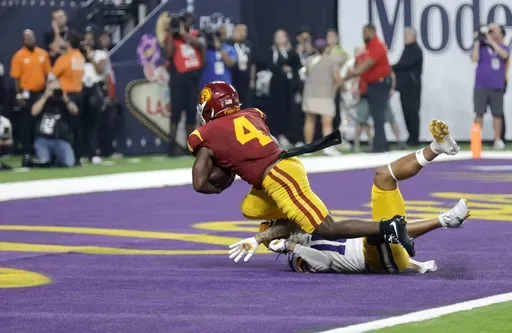 Southern California running back Woody Marks (4) scores the winning touchdown past LSU safety Dashawn Spears (10) during the second half of an NCAA college football game Sunday, Sept. 1, 2024, in Las Vegas. (AP Photo/Steve Marcus)