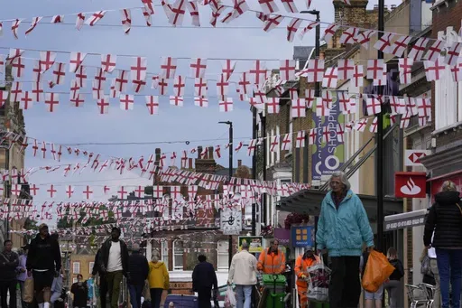 People walk alone the street in Dartford, London, Wednesday, June 12, 2024.Distrust saturates the campaign trails in the United States and Great Britain like the dense summer heat as each country, rooted in the Magna Carta, revolution and a "special relationship," hurtle toward democratic elections. Brits go to the polls July 4 -- as Americans celebrate their independence with barbeques and fireworks ahead of the U.S. presidential election in November. In both places, voters articulated a striki