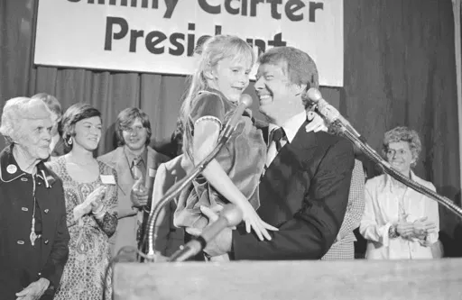 Georgia Gov. Jimmy Carter holds his daughter, Amy, just after he made his official announcement that he would seek the Democratic nomination for presidency on Dec. 13, 1974, in Atlanta. (AP Photo, File)
