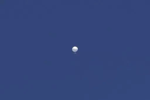 A balloon floats over Columbia, Mo., on Friday, Feb. 3, 2023. A huge, high-altitude Chinese balloon sailed across the U.S. on Friday, drawing severe Pentagon accusations of spying despite China's firm denials. (Anna Griffin/Missourian via AP)