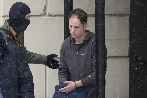 Wall Street Journal reporter Evan Gershkovich is escorted from court after a hearing in Moscow, Russia, Friday, Jan. 26, 2024. Arrests of Americans in Russia have become increasingly common as relations between Moscow and Washington sink to Cold War lows. Some have been exchanged for Russians held in the U.S., while for others, the prospects of being released in a swap are less clear. (AP Photo/Alexander Zemlianichenko, File)