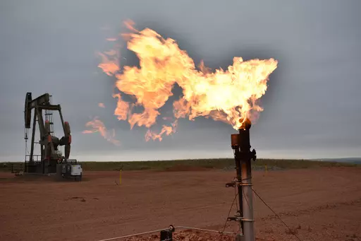 A flare burns natural gas at an oil well, Aug. 26, 2021, in Watford City, N.D. A lawsuit that Louisiana and other Republican-leaning states filed challenging figures the Biden administration uses to calculate damages from greenhouse gasses was dismissed Wednesday, April 5, 2023, by a federal appeals court. (AP Photo/Matthew Brown, File)