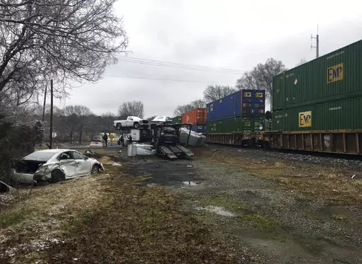 This photo provided by Caddo Sheriff's office shows the scene of a crash involving a train and an 18-wheeler, on Friday, Feb. 4, 2022 near Greenwood, La.  LA-169 is shut down from Greenwood all the way to South Lakeshore as Caddo Sheriff’s deputies work a major crash involving a train and an 18-wheeler, said Sheriff Steve Prator.  (Caddo Sheriff's Office via AP)