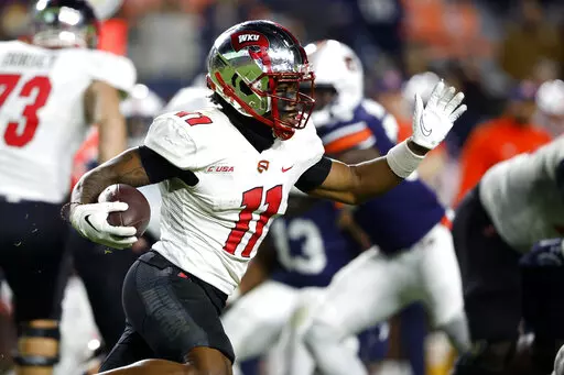 Western Kentucky wide receiver Malachi Corley (11) carries the ball against Auburn during the second half of an NCAA college football game, Saturday, Nov. 19, 2022, in Auburn, Ala. (AP Photo/Butch Dill)