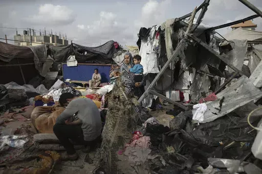 Displaced Palestinians inspect their tents destroyed by Israel's bombardment, adjunct to an UNRWA facility west of Rafah city, Gaza Strip, Tuesday, May 28, 2024. (AP Photo/Jehad Alshrafi, File)