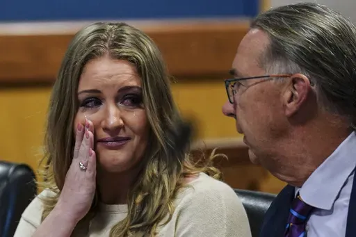 Jenna Ellis speaks with her attorney Franklin Hogue after Ellis plead guilty to a felony count of aiding and abetting false statements and writings, Oct. 24, 2023, inside Fulton Superior Court Judge Scott McAfee's Fulton County, Ga., courtroom in Atlanta. (AP Photo/John Bazemore, Pool, File)