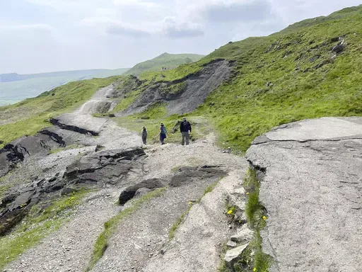 Hikers make their way along Mam Tor, a 517 meters high (1,696 feet) hill in England’s Peak District National Park on May 8, 2024. (Steve Wartenberg via AP)