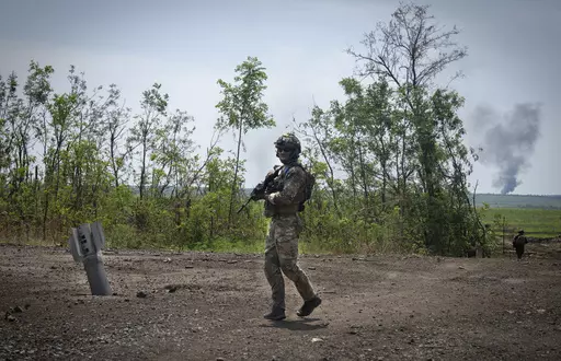 Ukrainian soldiers walk in their positions on the frontline in Zaporizhzhia region, Ukraine, Friday, June 23, 2023. In the southeastern Zaporizhzhia region, Ukrainian troops - backed by tanks, artillery and drones - have broken through initial Russian fighting positions and continue to make steady gains south of Velyka Novosilka near the administrative border with Donestk and south of Orikhiv, while confronting heavy bombardment in wide open fields with little cover. (AP Photo/Efrem Lukatsky, Fi