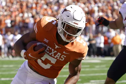 Texas running back Bijan Robinson (5) runs against Oklahoma State during the first half of an NCAA college football game in Austin, Texas, Saturday, Oct. 16, 2021. Robinson was named to The Associated Press preseason All-America NCAA college football first team, Monday, Aug. 22, 2022. (AP Photo/Chuck Burton, File)